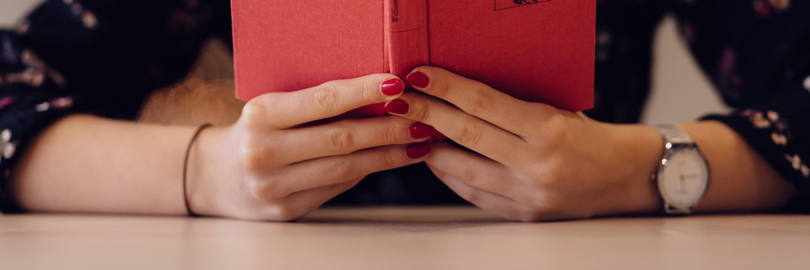 female hands holding an open book upright