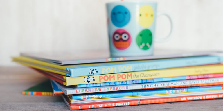 A stack of colorful children's books.