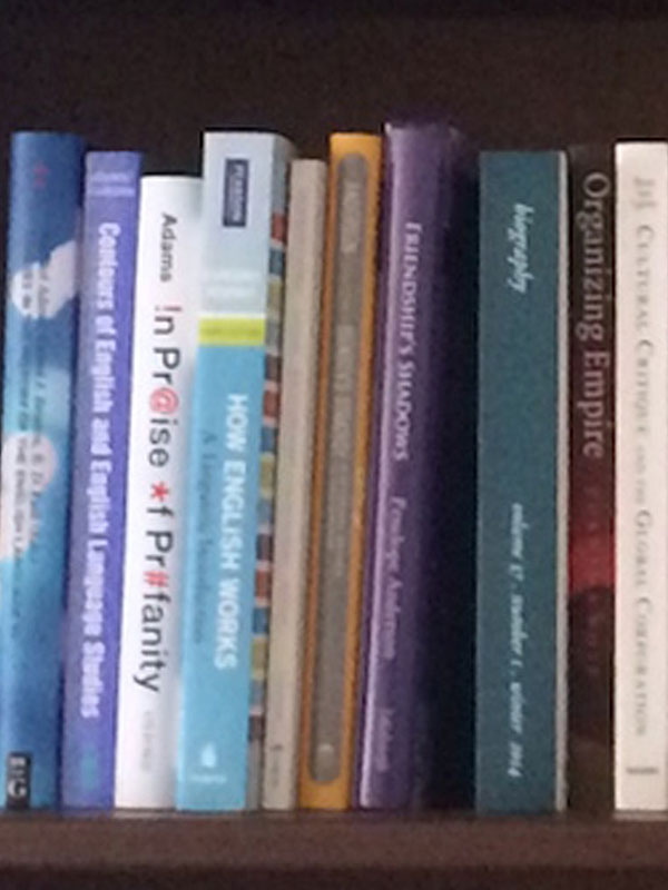 A bookshelf filled with books published by current faculty members in the Department of English.